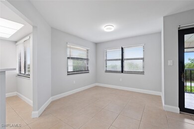 Empty room with light tile patterned floors, baseb