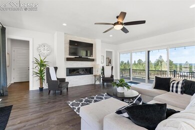 Entertainment wall includes lateral fireplace
