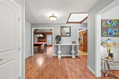 Hallway featuring a textured ceiling, wood-type fl
