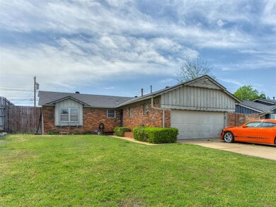 Ranch-style home with driveway, a front yard, bric
