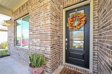 This inviting entryway blends classic brick architecture, the black front door serves as a bold focal point.