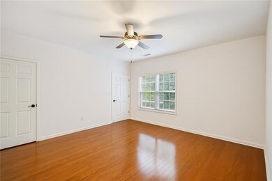 Unfurnished room featuring wood finished floors and a ceiling fan