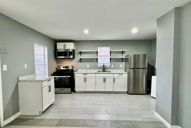 UPDATED KITCHEN WITH WHITE CABINETS.