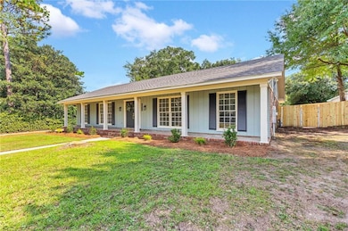 View of front of house with a porch, board and batten siding, and a shingled roof