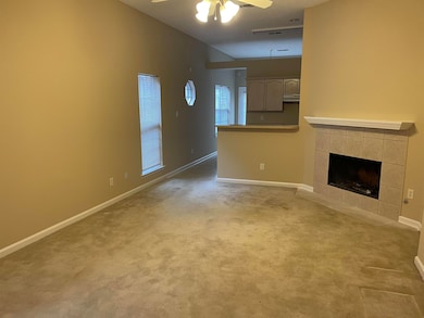 Unfurnished living room with a fireplace, carpet f