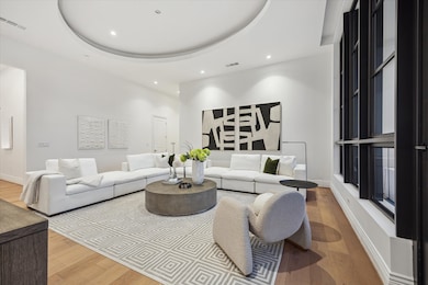 Designed for both comfort and style, this expansive space easily accommodates large-scale furnishings, creating an inviting setting for elegant entertaining or relaxed living. Cove lighting accentuates the architectural details while the 13 foot ceilings create an airy expansive feel.
