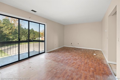 Spare room featuring hardwood / wood-style flooring and baseboards