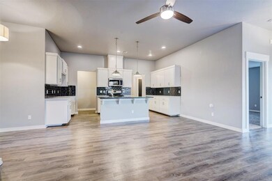 Kitchen featuring light wood-type flooring, white 