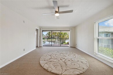 Carpeted spare room featuring ceiling fan and baseboards