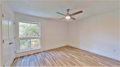 Empty room featuring light wood-style floors, bas