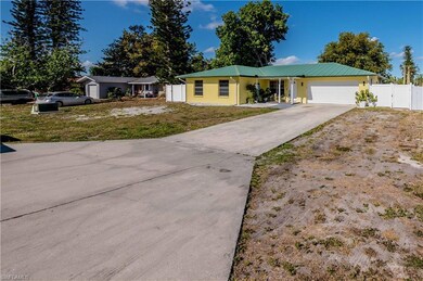 Ranch-style house featuring stucco siding, fence, 