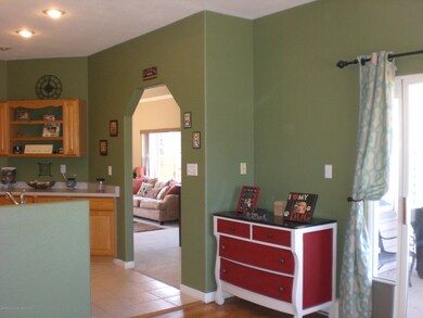 Kitchen view to LR and exterior slider t