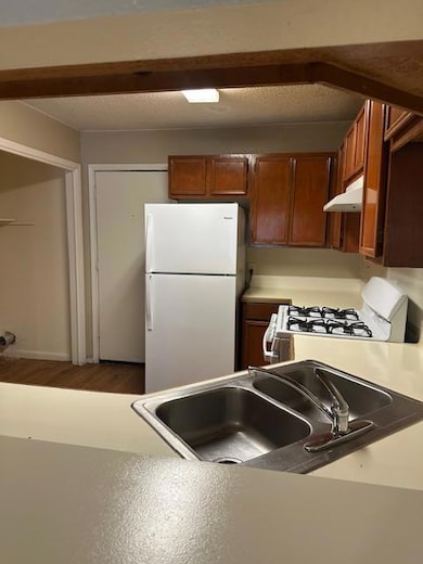 Kitchen with freestanding refrigerator, stove, a 