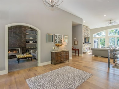 Main floor library with gas fireplace off entry