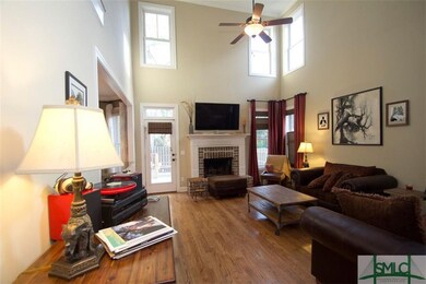 Great room with soaring ceiling, hardwood floors, 