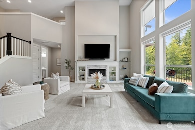 Gas Fireplace with FLoor to Ceiling Fireplace Bump out with glass insert with fan, Stacked stone Fireplace surround with Wood Mantle and custom built-in shelves