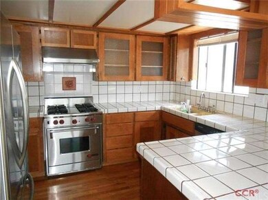Kitchen with hardwood floors, newer Wolf range, st