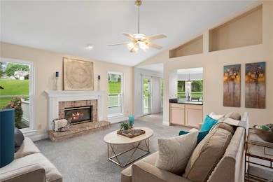 Great room has newer carpeting, vaulted ceiling, c