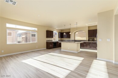 Kitchen with stainless steel microwave, light wood