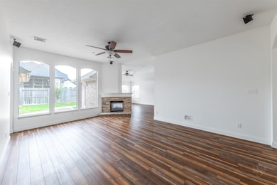 This open living room is a captivating blend of comfort and elegance, with abundant natural light streaming in through the expansive windows. The thoughtful design of the room allows the warmth of natural light to permeate the space, creating a welcoming and airy ambiance.