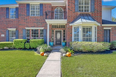 This inviting front entry showcases timeless brick architecture accented with elegant shutters and manicured landscaping. A charming walkway leads to a covered porch with double columns and an upgraded front door framed by large windows, creating a warm and welcoming first impression. The attention to detail and curb appeal make this home truly stand out.