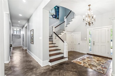 The grand foyer features a sweeping staircase and