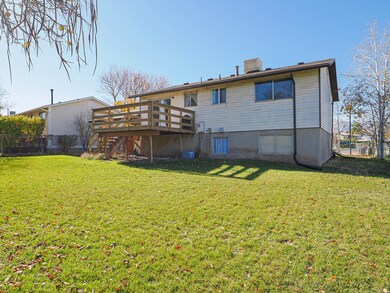 Back of house featuring a deck and stairs
