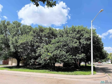 View of asphalt street featuring street lights, sidewalks, and curbs