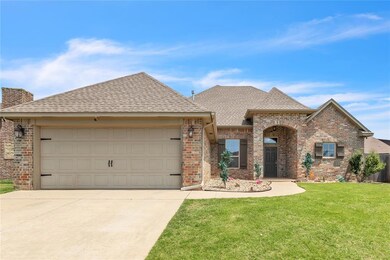 View of front of house with a garage and a front lawn