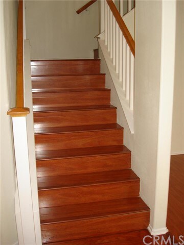 SPLIT STARIWAY WITH RICH MAHOGANY LAMINATE FLOORIN
