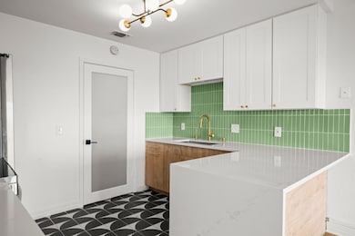 Updated cabinetry, countertops, backsplash, flooring, and lighting