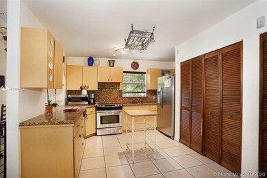 The fully equipped kitchen with the washer and dryer behind the bi-fold doors