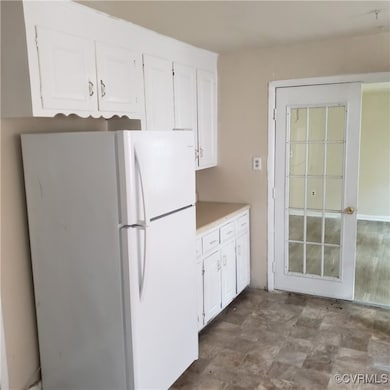 Kitchen with white refrigerator, light tile patter