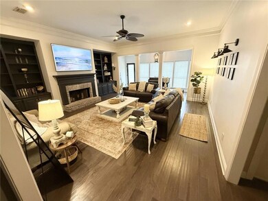 Open living room with built in bookcases and a fireplace