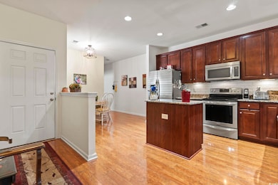 Kitchen with decorative backsplash, light stone co
