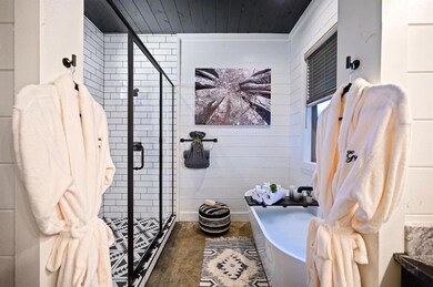 Bathroom featuring shower with separate bathtub