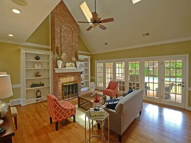 Great room with vaulted ceiling, wood floor, built