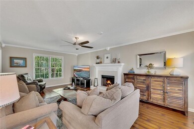 Cozy up by the fireplace in this inviting living space, perfect for relaxing or entertaining.