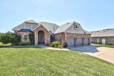 View of front of home with a front yard and a gara