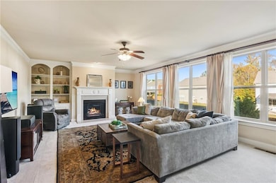 Spacious living room features a cozy fireplace and built-in shelving, providing excellent storage.