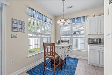 Tiled dining room with an inviting chandelier