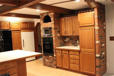 Lots of cabinets, wood beams on the ceiling and br