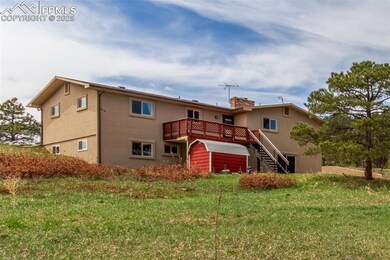 Left side of the home from the road. Deck looks onto the pastures and barn.