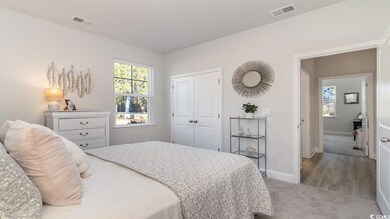 Carpeted bedroom with a closet