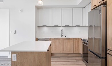 Kitchen with a sink, tasteful backsplash, applianc