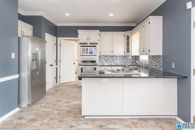 Recently renovated kitchen with white cabinets, gr