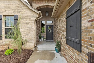 Entrance to property with stone siding and brick s