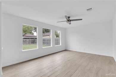 Unfurnished room featuring a healthy amount of sunlight, light wood-type flooring, and ceiling fan