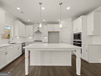 Westerly updated kitchen with a larbe quartz topped center island for bar seating