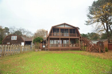 Rear of home and steps down. Two detached storage sheds.